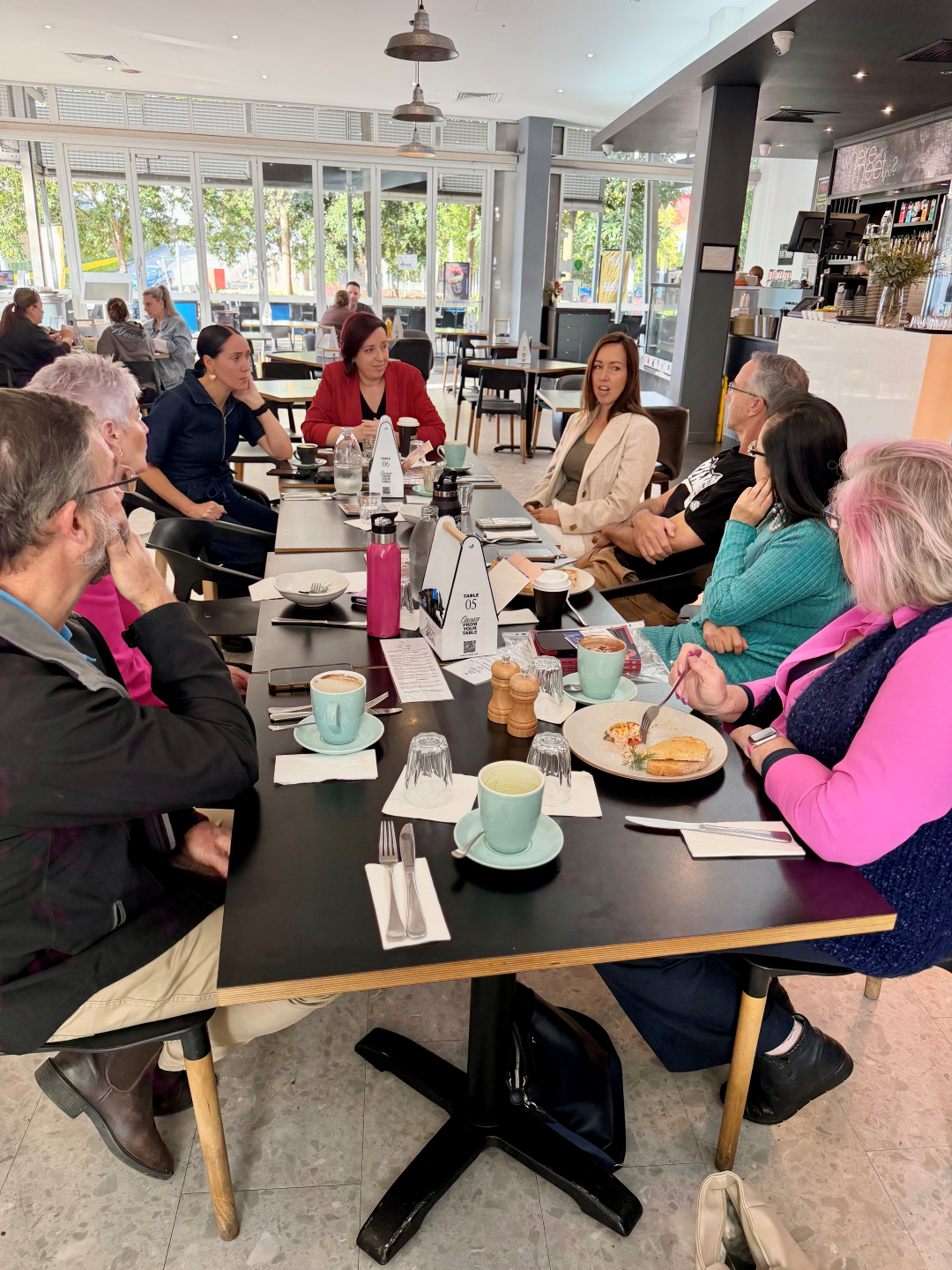People connecting at a community breakfast gathering
